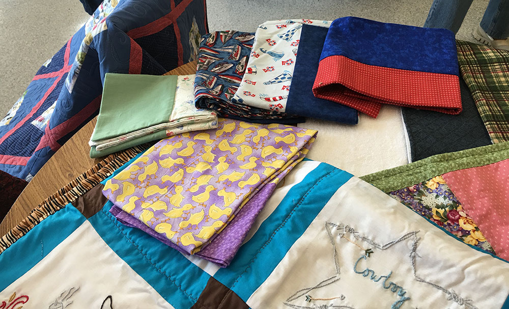 An assortment of pillowcases and bags for foster children